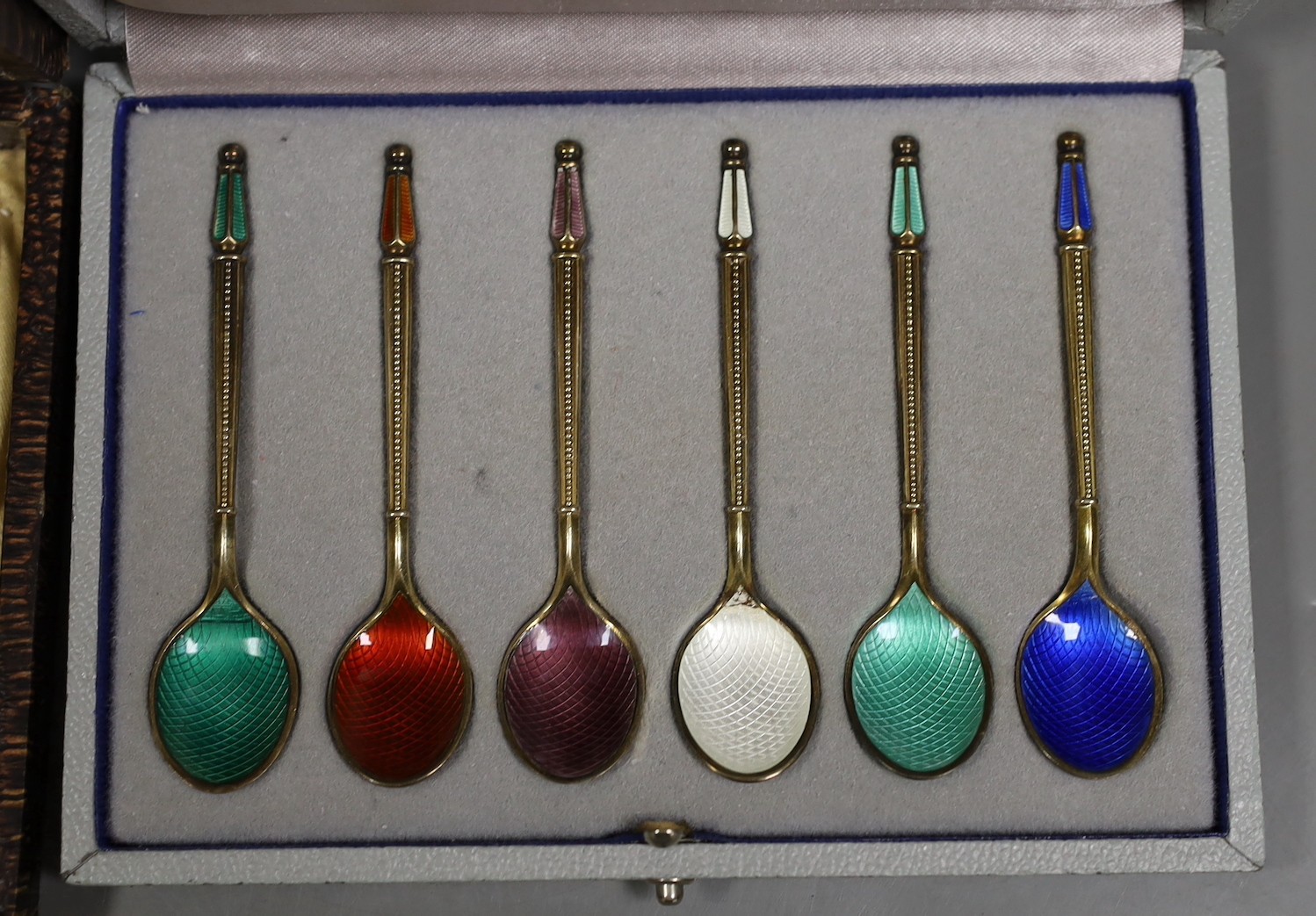 A set of of twelve Danish sterling and polychrome enamel coffee spoons, by W & S Sorenson, 94mm and a similar cased set of six coffee spoons by A. Michelsen.